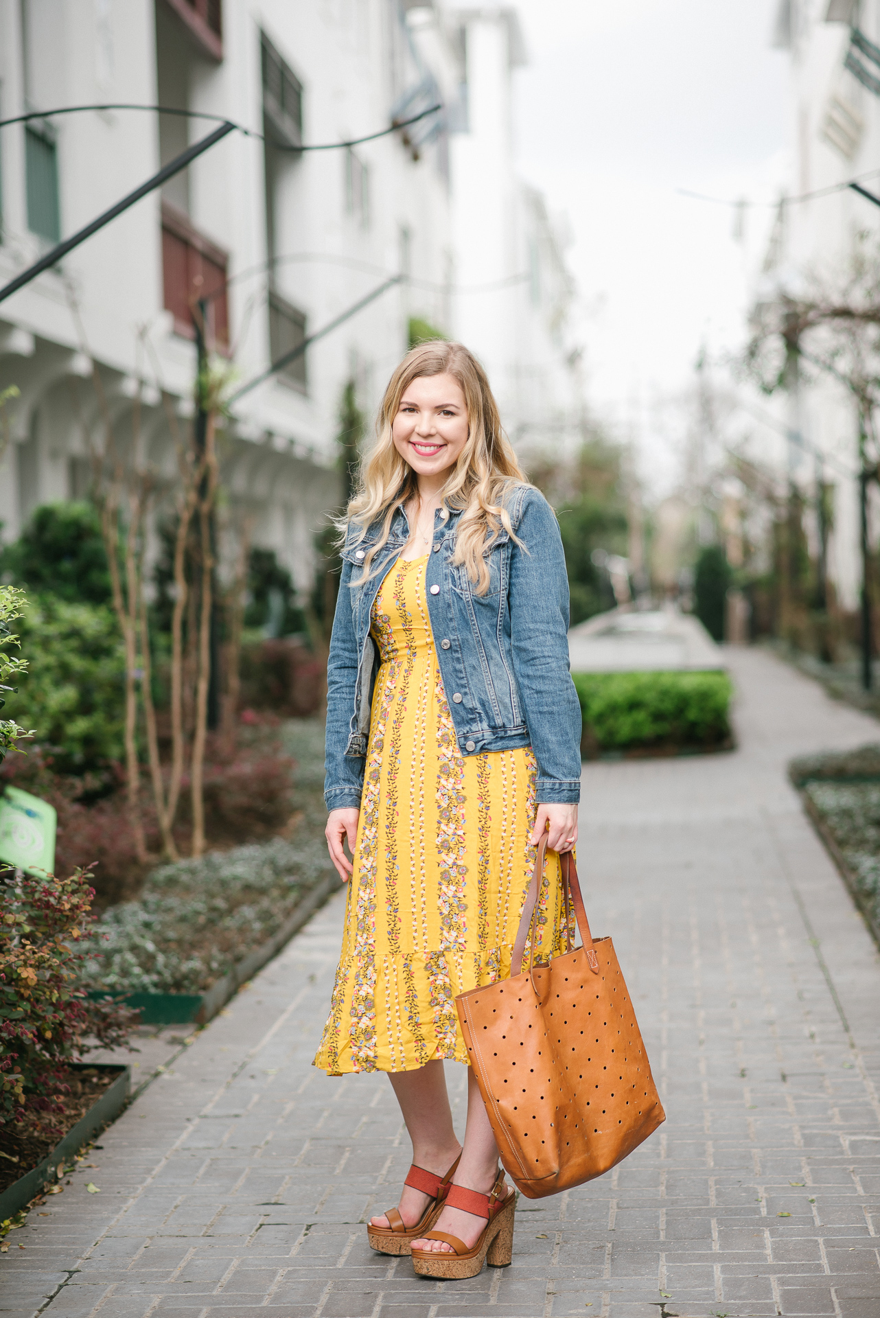 Yellow Floral Dress, Denim Jacket and Madewell Brown Leather Tote Worn By Jillian Goltzman of Cup of Charisma