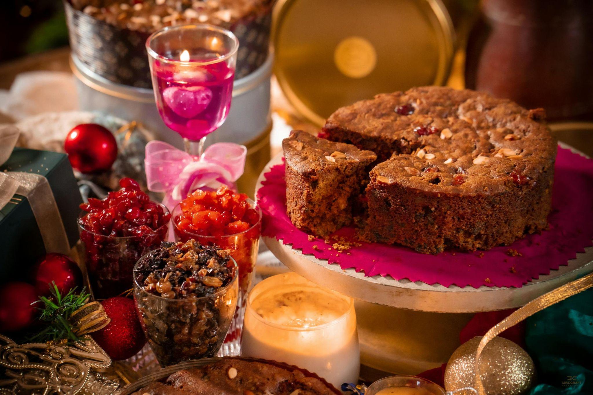  Artisan chocolate bar, gourmet cake, and a mini jar of nut butter arranged on a wooden surface